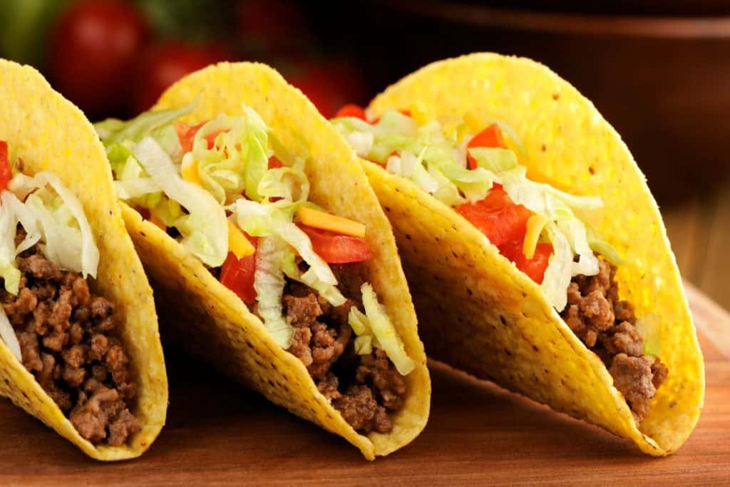 Tre tacos med hårt skal på ett bord